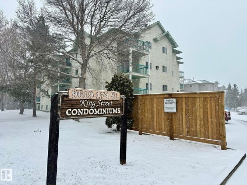 King Street Condominiums featuring a multi-story building with balconies and a wood privacy fence - 211 9619 174 Street, Edmonton, AB - Outdoor