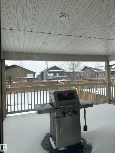 Covered outdoor deck with a perforated soffit ceiling and recessed lighting - 4926 58 Ave, Cold Lake, AB - Outdoor