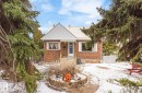 Brick exterior with white trim and a contrasting blue front door - 7703 77 Avenue, Edmonton, AB 