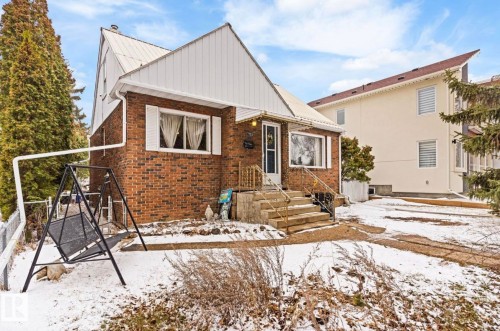 Brick exterior residence with white siding accents and a metal roof - 7703 77 Avenue, Edmonton, AB 