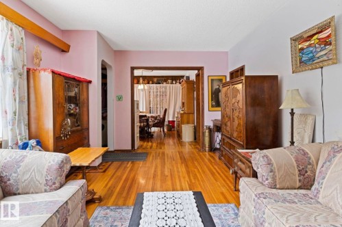 Hardwood-style flooring extends through the main room and into a rear area - 7703 77 Avenue, Edmonton, AB 