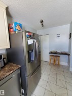 Stainless steel French door refrigerator with ice and water dispenser, complemented by a coordinating stainless steel dishwasher - 