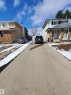 Concrete driveway and front walkway leading to a two-story residence with a covered entry - 11814 157 Avenue, Edmonton, AB  - Outdoor 