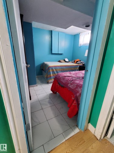 Room featuring white tile flooring and blue-painted walls - 11814 157 Avenue, Edmonton, AB - Indoor