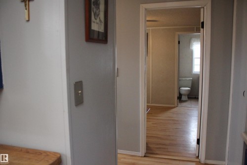 Interior hallway featuring light wood-finish flooring and neutral wall tones - 4839 49 Avenue, Chipman, AB - Indoor Photo Showing Other Room