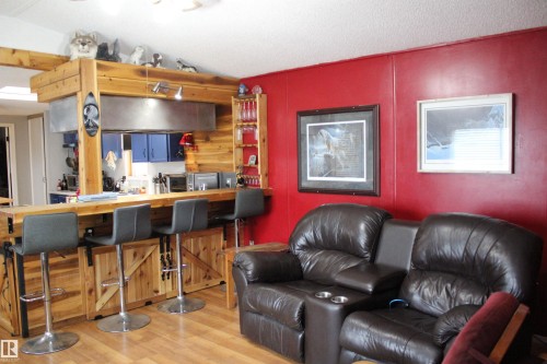 Open-concept kitchen and living area featuring wood-finish flooring - 4839 49 Avenue, Chipman, AB - Indoor Photo Showing Living Room