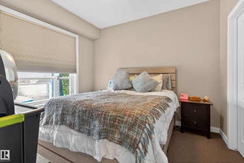 Bedroom featuring light tan wall paint and a white ceiling - 409 2584 Anderson Way, Edmonton, AB - Indoor Photo Showing Bedroom