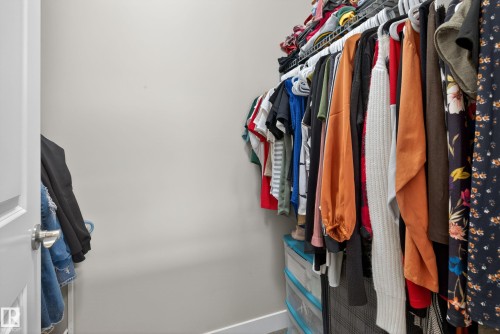 Walk-in closet featuring light gray wall paint and built-in wire shelving - 409 2584 Anderson Way, Edmonton, AB - Indoor With Storage