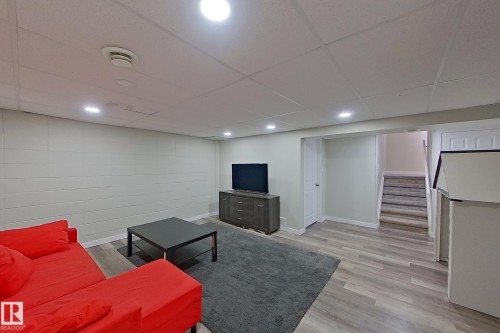 Finished living area featuring recessed lighting, light wood-look flooring, and a neutral color palette - 184 Cornell Court, Edmonton, AB - Indoor Photo Showing Basement