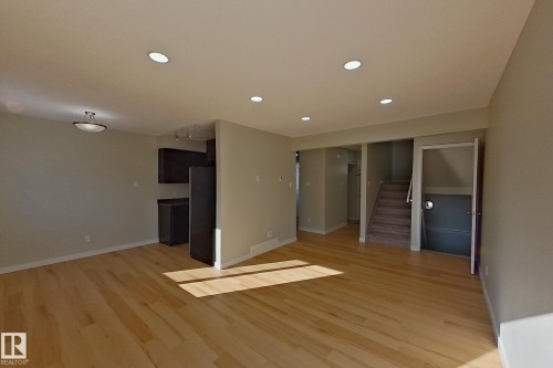 Open concept living area featuring light-toned hardwood floors and recessed lighting - 184 Cornell Court, Edmonton, AB - Indoor Photo Showing Other Room