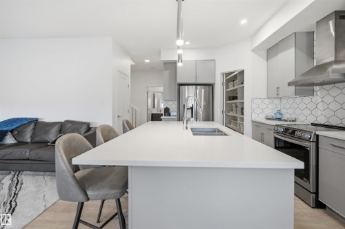 Kitchen island featuring a single-basin sink with a gooseneck faucet - 7782 174A Avenue, Edmonton, AB - Indoor Photo Showing Kitchen With Double Sink With Upgraded Kitchen