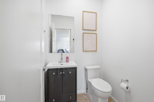 Modern vanity with a rectangular basin sink, chrome faucet, and mirrored cabinet - 7782 174A Avenue, Edmonton, AB - Indoor Photo Showing Bathroom