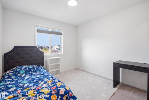 Bright interior space with white walls and a large window providing natural light - 7782 174A Avenue, Edmonton, AB - Indoor Photo Showing Bedroom