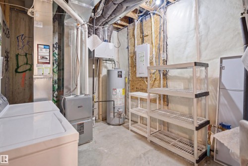Utility space featuring a water heater, furnace, and exposed ceiling joists - 7782 174A Avenue, Edmonton, AB - Indoor Photo Showing Laundry Room