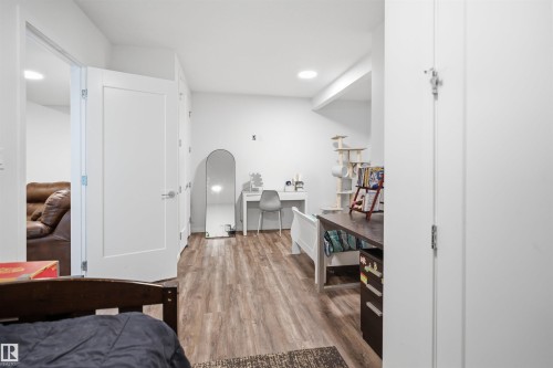 Interior space featuring wood-finish flooring, white walls, and recessed lighting - 7782 174A Avenue, Edmonton, AB - Indoor