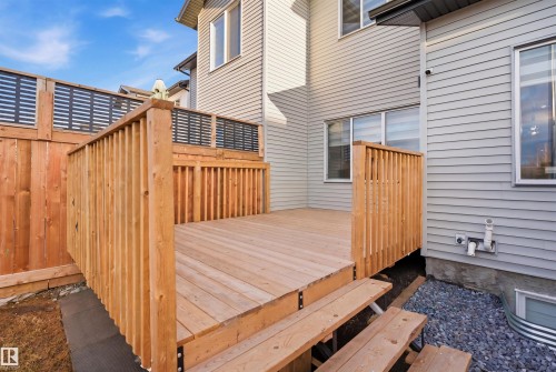 Expansive wood deck with stairs, featuring a slatted wood privacy fence and exterior siding - 7782 174A Avenue, Edmonton, AB - Outdoor With Exterior