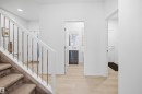 Staircase with carpeted treads and white railing featuring metal balusters - 7782 174A Avenue, Edmonton, AB  - Indoor Photo Showing Other Room 