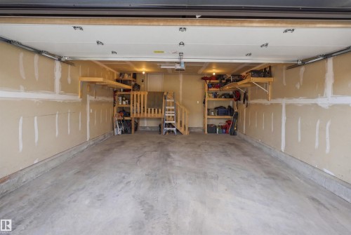 Spacious two-car garage featuring a concrete floor and beige walls - 7782 174A Avenue, Edmonton, AB - Indoor Photo Showing Garage