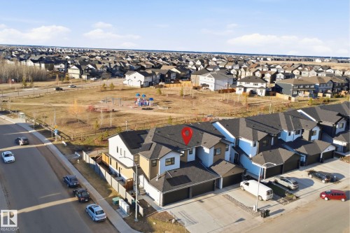 Contemporary multi-story exterior featuring a black shingle roof, light-toned siding, and an attached two-car garage - 7782 174A Avenue, Edmonton, AB - Outdoor With View