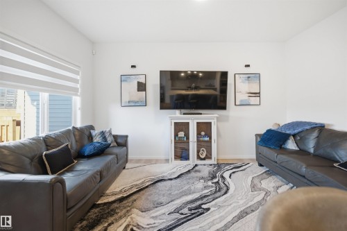 Spacious living area featuring light wood-finish flooring and bright white walls - 7782 174A Avenue, Edmonton, AB - Indoor Photo Showing Living Room