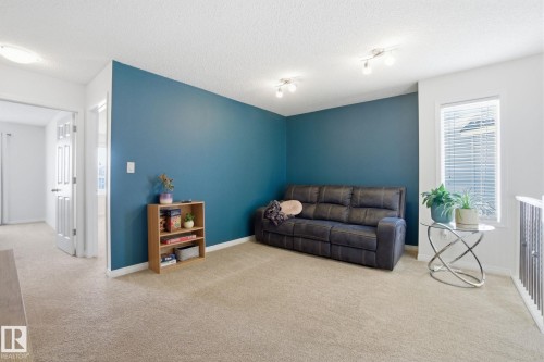 This versatile space features carpeting, a window with blinds, and recessed lighting - 2553 Coughlan Road, Edmonton, AB - Indoor