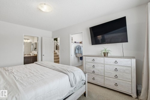 This room features light-colored carpeting and walls, providing a bright and airy atmosphere - 2553 Coughlan Road, Edmonton, AB - Indoor Photo Showing Bedroom