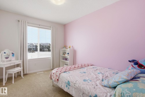 Bedroom featuring a window with blinds, carpeted flooring, and a light fixture on the ceiling - 2553 Coughlan Road, Edmonton, AB - Indoor Photo Showing Bedroom