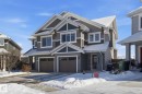 The property features a two-story design with gray siding and white trim accents - 2553 Coughlan Road, Edmonton, AB  - Outdoor With Facade 