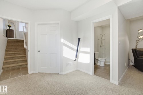 This property features a carpeted room with light-colored walls - 2553 Coughlan Road, Edmonton, AB - Indoor Photo Showing Other Room