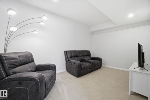 The room features light-colored carpeting, white walls, and recessed lighting - 2553 Coughlan Road, Edmonton, AB - Indoor