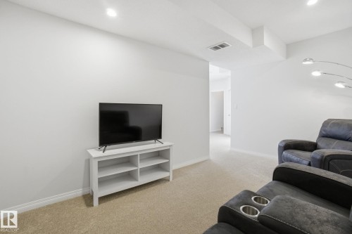 This room features light-colored carpeting, white walls, and recessed lighting - 2553 Coughlan Road, Edmonton, AB - Indoor