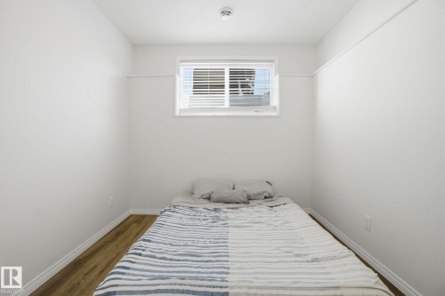 Room featuring hardwood floors and a window with blinds - 2553 Coughlan Road, Edmonton, AB - Indoor Photo Showing Bedroom
