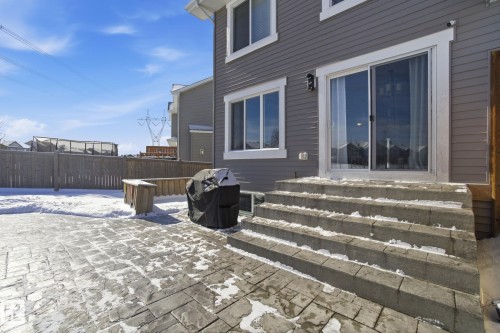 The property features a concrete patio with a paved surface and a wooden fence - 2553 Coughlan Road, Edmonton, AB - Outdoor