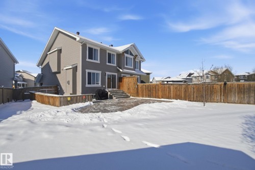 The property features a private fenced yard with a paved patio area - 2553 Coughlan Road, Edmonton, AB - Outdoor