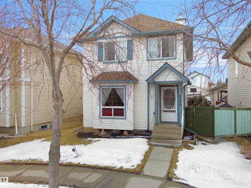Two-story residence featuring light-colored siding with contrasting blue trim accents and shutters - 21379 89 Avenue Nw, Edmonton, AB - Outdoor