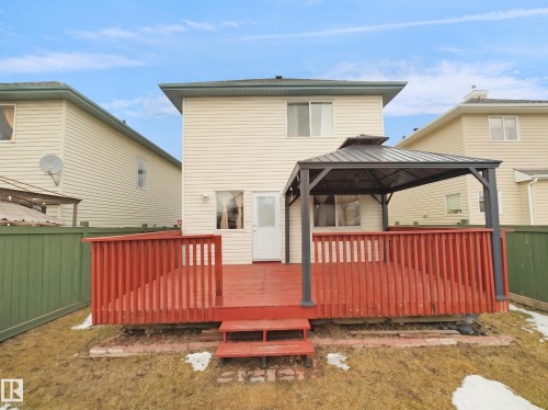 Exterior deck with red-stained wood and a metal-framed gazebo - 21379 89 Avenue Nw, Edmonton, AB - Outdoor With Exterior