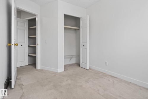 Neutral-toned carpeting paired with white walls - 18604 97A Avenue, Edmonton, AB - Indoor Photo Showing Other Room