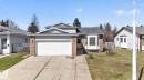 Split-level residence featuring a two-car garage, brick accents, and a bay window - 18604 97A Avenue, Edmonton, AB  - Outdoor With Facade 