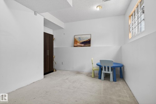 Neutral-toned carpeting complements the white walls - 18604 97A Avenue, Edmonton, AB - Indoor Photo Showing Other Room