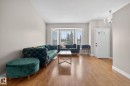 Spacious living area featuring wood-finish flooring, a prominent bay window, and neutral wall tones - 18604 97A Avenue, Edmonton, AB  - Indoor Photo Showing Living Room 