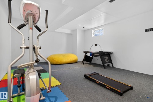 Finished lower level featuring a drop ceiling, recessed lighting, and a single block window - 18604 97A Avenue, Edmonton, AB - Indoor Photo Showing Gym Room