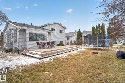 Rear exterior with light gray siding, featuring a multi-level wood-finish deck - 18604 97A Avenue, Edmonton, AB - Outdoor
