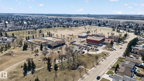 Expansive aerial view showcasing a large community park with mature trees, established residential areas, and a paved road network - 18604 97A Avenue, Edmonton, AB - Outdoor With View