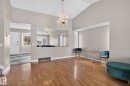 Spacious living area featuring wood-finish flooring, a vaulted ceiling, and a prominent chandelier - 18604 97A Avenue, Edmonton, AB  - Indoor Photo Showing Other Room 