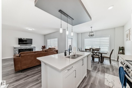 7035 Chivers Loop, Edmonton, AB - Indoor Photo Showing Kitchen With Fireplace With Double Sink