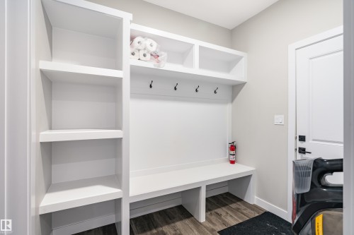 Built-in mudroom organization featuring an open bench, storage cubbies, shelving, and wall-mounted hooks - 2 Edison Drive, St. Albert, AB - Indoor Photo Showing Other Room