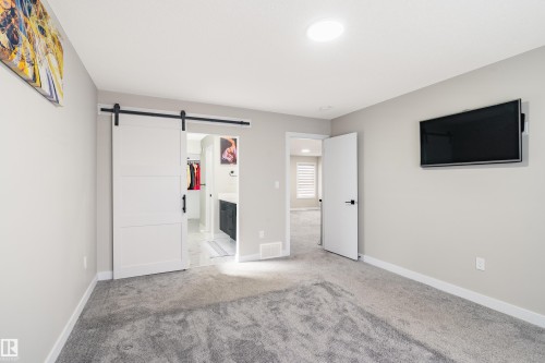 Spacious room featuring light gray carpeting and neutral wall paint - 2 Edison Drive, St. Albert, AB - Indoor Photo Showing Other Room