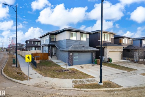 Modern two-story residence featuring a two-tone exterior with dark gray siding and lighter upper-level panels - 2 Edison Drive, St. Albert, AB - Outdoor With Facade
