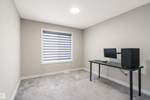 Neutral tone walls complement the light-colored carpet flooring - 2 Edison Drive, St. Albert, AB - Indoor