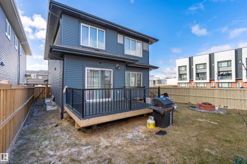 Two-story exterior with horizontal siding, featuring a rear deck with black railings and privacy fencing - 2 Edison Drive, St. Albert, AB - Outdoor With Deck Patio Veranda With Exterior